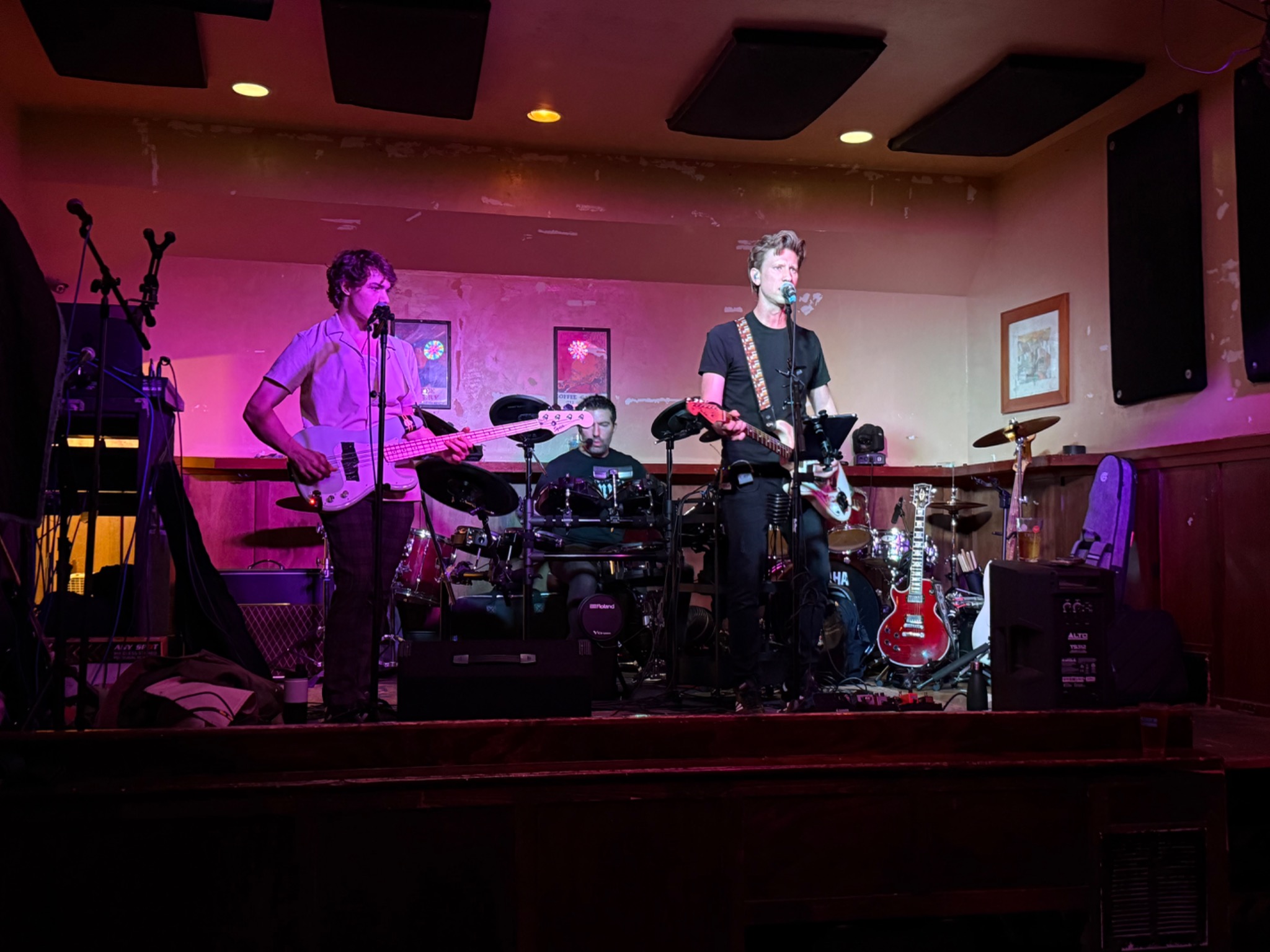 David singing and playing guitar with a full band